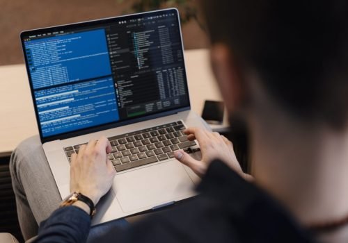 close-up-man-writing-code-laptop-scaled-1-1024x683.jpg